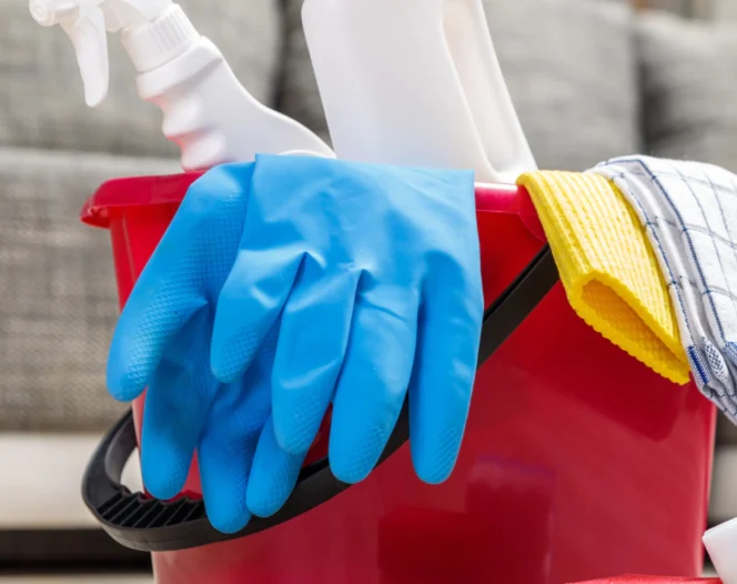 a bucket full of cleaning tools