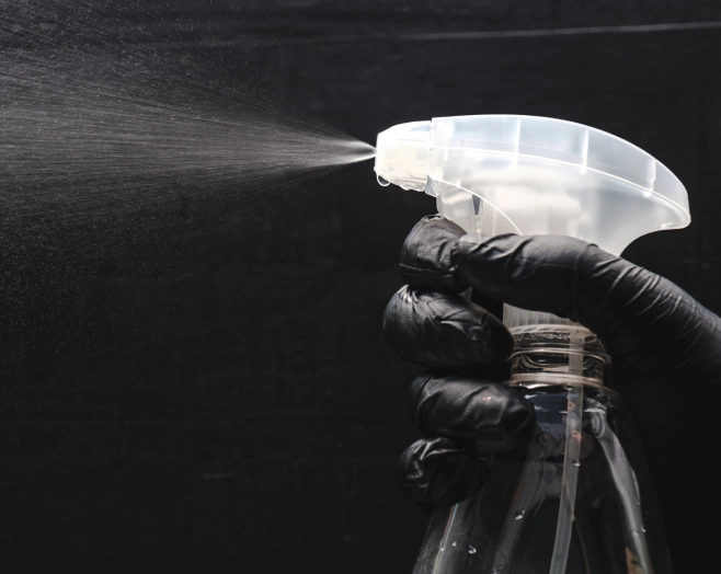 someone using a spray bottle